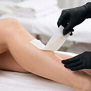 Professional waxing treatment on a woman's leg at Newport Nails.