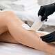 Professional waxing treatment on a woman's leg at Newport Nails.